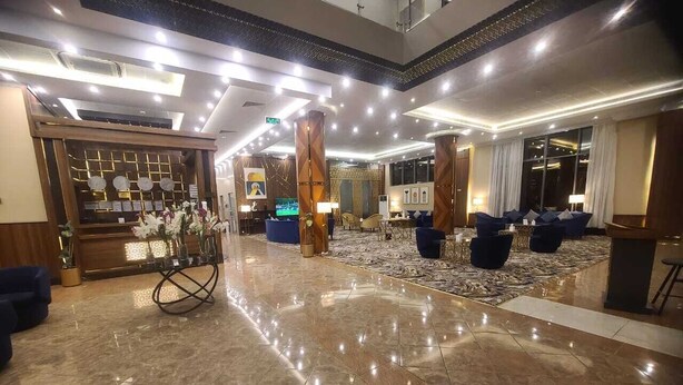 A spacious lobby with a marble floor, a reception desk, and seating areas. - Smayah Hotel (Riyadh)