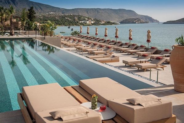 Outdoor pool, open 8:00 AM to 8:00 PM, pool umbrellas, pool loungers