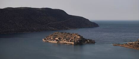 A coastal town with a fortified structure surrounded by water.