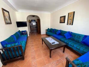 Apartamento, 2 quartos, sacada, vista para o jardim | Sala de estar