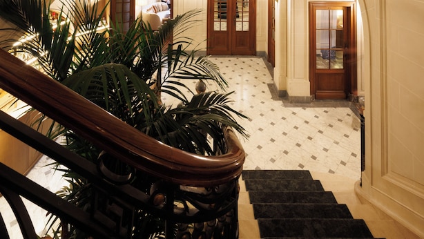 A grand staircase with ornate railings and a polished marble floor. - Hotel Fleur de Ville (Brussels)