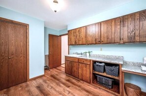 Una cocina con armarios de madera, encimera de granito y un fregadero.