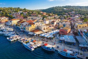 Experience the vibrant waterfront area with a marina, colorful buildings, and bustling street scene.