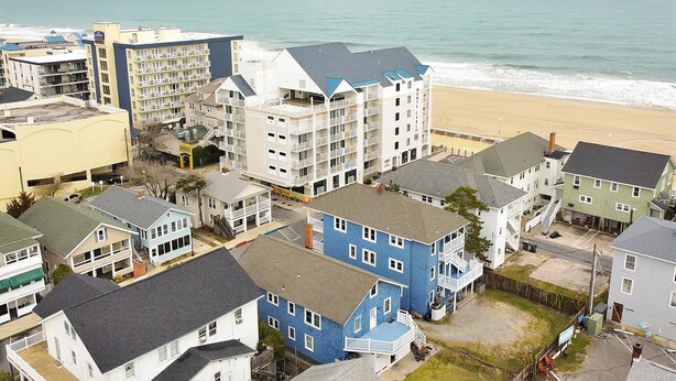A coastal residential area with multi-story buildings, including a hotel named 'Monte Carlo'.