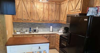 Studio cabin #3 with lake view and boat dock access, outdoor seating.