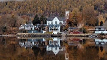 A lakeside village with a prominent white church and residential buildings.