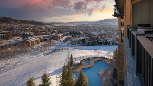 A view of a residential area with snow-covered houses and a swimming pool.