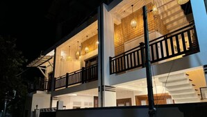 A two-story building with a balcony on the upper floor, a gated entrance, and a staircase leading to the upper level. - Surf 247 Weligama Villa (Weligama)