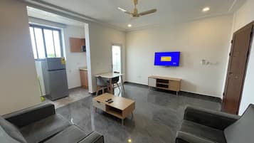 Deluxe Apartment | Living area | 32-inch Smart TV with cable channels, Netflix, streaming services