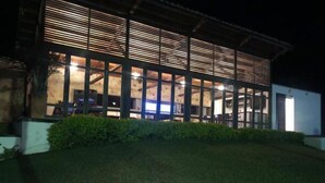 A modern building with large windows and a well-lit interior. - Casa Maria, Lagoon Calima (Club Las Anonimos)