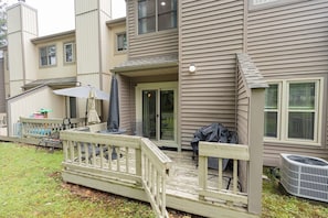 A residential property with a covered patio, outdoor furniture, and a sliding glass door entrance. - Family and pet-friendly, 2 Bedroom, 2 Bath, private townhome with wood-burning fireplace and jacuzzi tub (East Stroudsburg)
