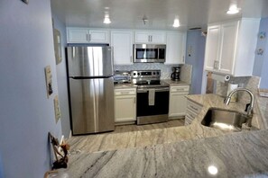 Fridge, microwave, oven, stovetop - OCEAN BLISS- Stylish Beach Themed Oceanfront Condo, Pool,HotTub -SandDollar801 (Daytona Beach)