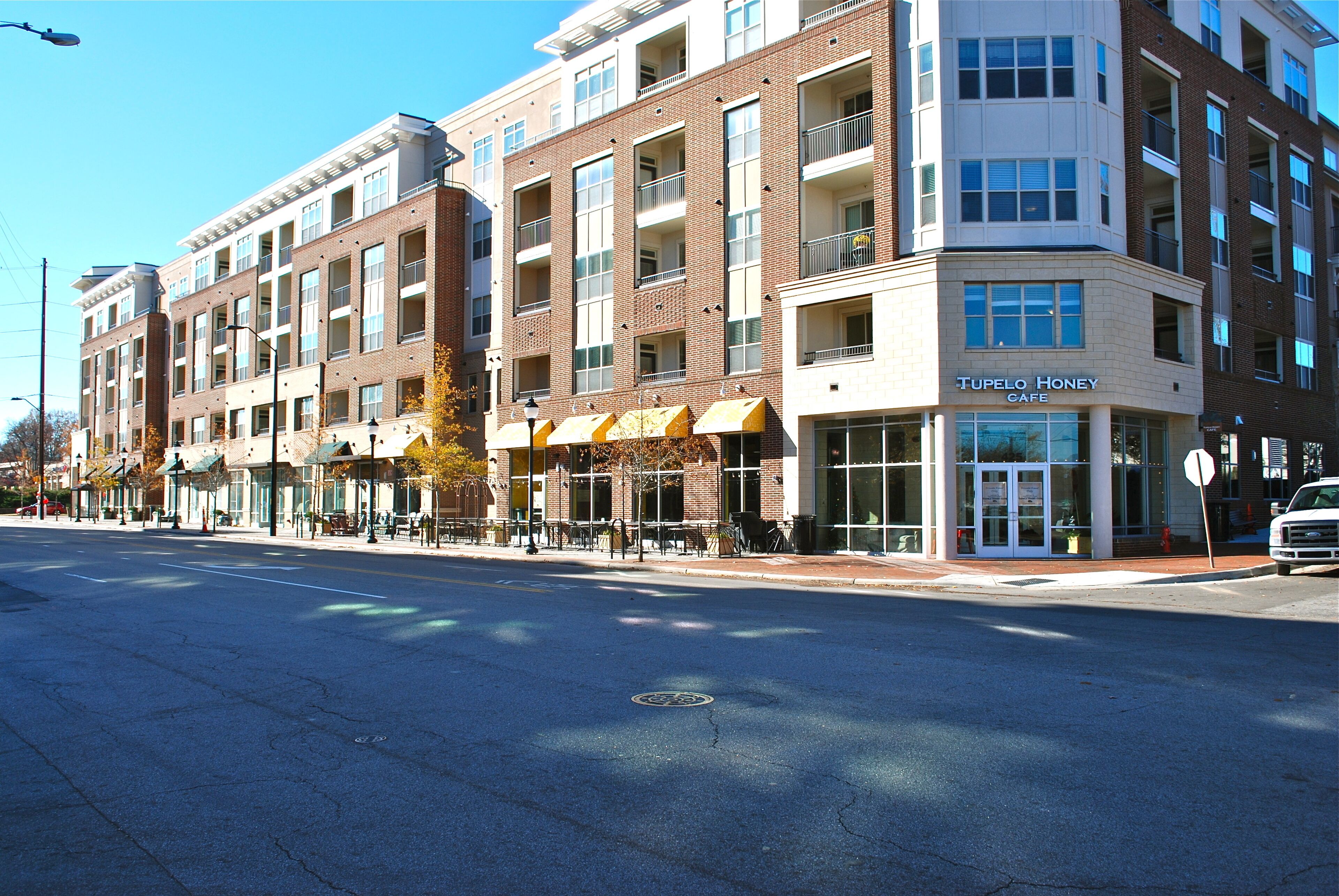 A multi-story building with a cafe named "Tupelo Honey Cafe" on the ground floor.