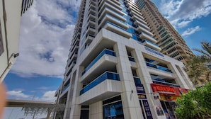 A modern high-rise building with multiple balconies and a clear sky. - Full Marina view - Opal Tower (Dubai)