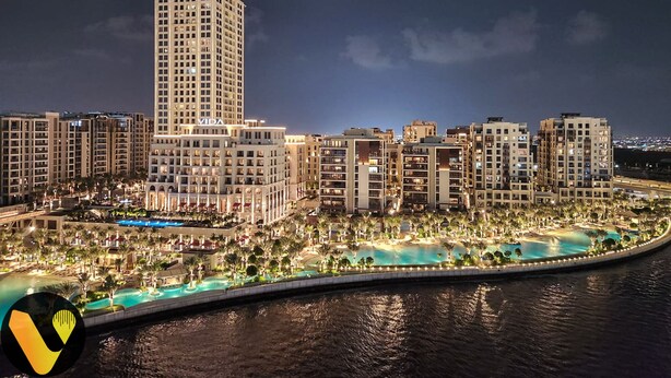 A high-rise hotel with a prominent tower, multiple buildings, and a waterfront pool area. - Palace Waterfront Living Dubai Creek  (Dubai)
