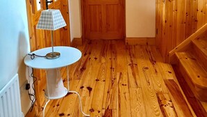 A wooden-floored hallway with a white table lamp, a door, and a staircase. - 2 min's to beautiful beach, amazing home for 8 peeps huge garden. Suits families (Portsalon)