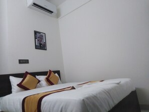 Economy Room | 1 bedroom, blackout drapes, soundproofing, free WiFi - J K Inn Hotel - Urban Express (Bengaluru)