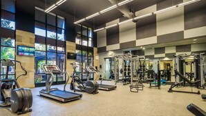 A gym with treadmills, elliptical machines, and weightlifting equipment. - Luxury Resort Condo by Six Flags Magic Mountain

 (Santa Clarita)