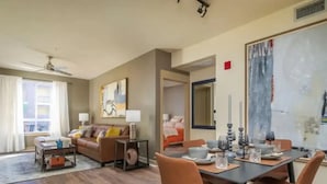 A spacious living room with a dining area, a sofa set, and a ceiling fan. - Luxury Resort Condo by Six Flags Magic Mountain

 (Santa Clarita)