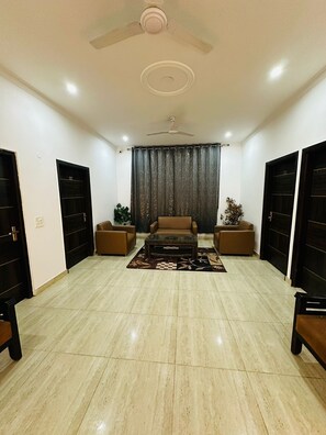 Business Double Room | Living area | 1-inch Smart TV with digital channels, MP3 dock, computer monitors - Vikrant Residency 177 (Gurugram)