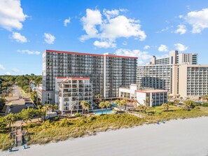 A beachfront hotel with multiple high-rise buildings, a swimming pool, and a beach area. - Family Oceanfront Condo Located in  North end of Myrtle Beach! (Myrtle Beach)
