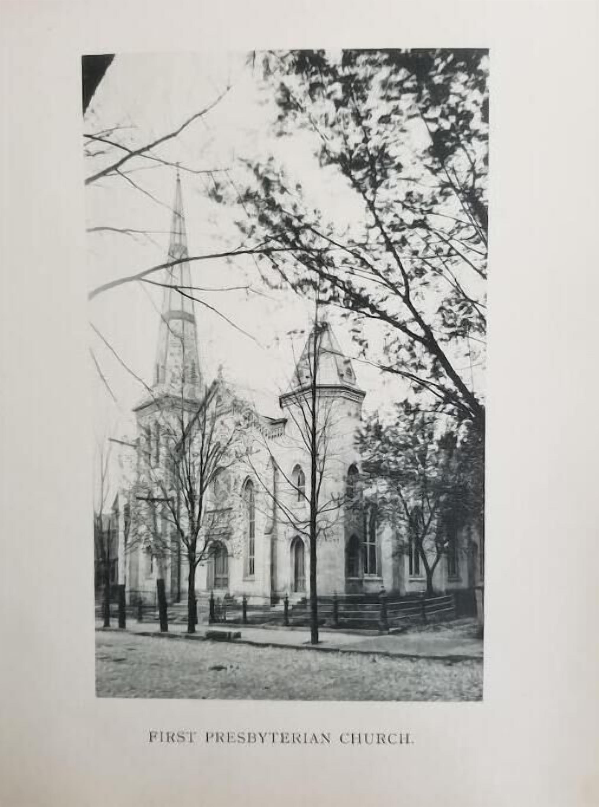 A black and white photograph of First Presbyterian Church with two prominent towers and a symmetrical facade.