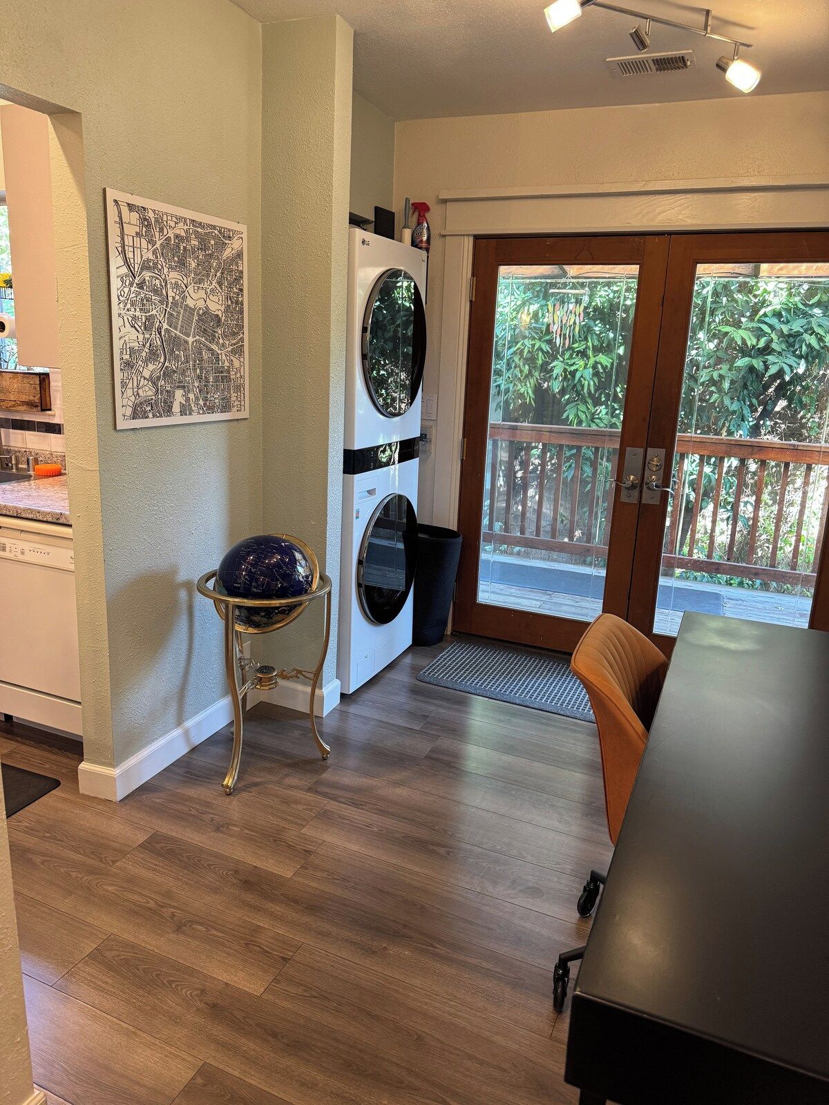 Una habitación con una mesa de comedor, una lavadora y un globo terráqueo sobre un pedestal.