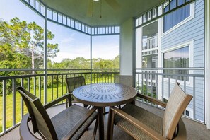 Enjoy a peaceful retreat with a balcony offering a serene view of the surrounding greenery.
