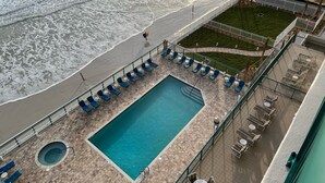 A rooftop pool with a view of the beach and ocean. - Life is better at the beach!  Stunning, oceanfront, corner-unit condominium. (Daytona Beach Shores)