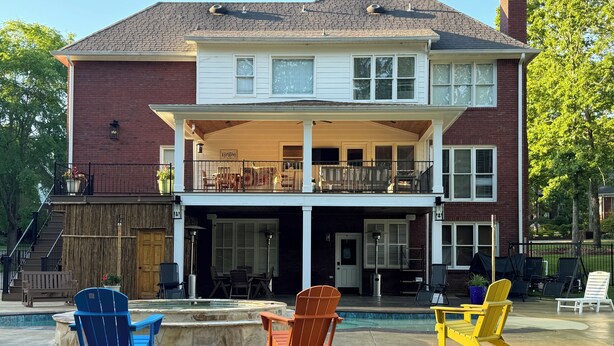 A two-story house with a covered patio area, outdoor seating, and a swimming pool. - Hidden Oasis in Scottsboro, AL (Scottsboro)