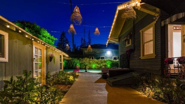 A pathway leading to a house with string lights and hanging lanterns. - Boho Vibe House with Pool near Hollywood (Los Angeles)