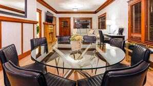 A dining area with a round glass table surrounded by black leather chairs. - Boho Vibe House with Pool near Hollywood (Los Angeles)