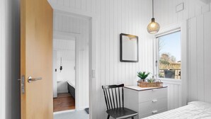 A bedroom with a bed, a desk with a chair, a window with a view, and a hanging light fixture. - 3 bedroom nice home in Hejls (Hejls)
