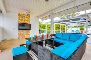 An outdoor patio with a sofa, table, and TV. - 6 Mi to Beach: Bradenton Home w/ Private Pool (Bradenton)