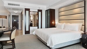 A modern hotel room with a large bed, a desk, and a chair. - FontaineBleau Resort Ocean plus Bay View w/ Balcony (Miami Beach)