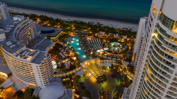 A resort with a central pool, multiple buildings, and a beach view. - FontaineBleau Resort Ocean plus Bay View w/ Balcony (Miami Beach)