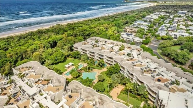 A coastal resort with multiple buildings, a beachfront, and a pool area. - Cotton Beach Resort (Casuarina)