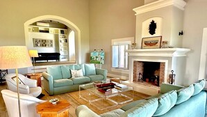 A spacious living room with a fireplace, a sofa, a coffee table, and a lamp. - Villa HERDADE DA BOAVISTA: 1.000 sqm house just for YOU! Capacity: 20 guests. (Aljustrel)