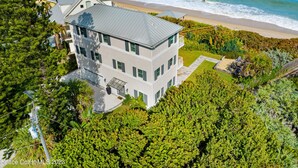 A multi-story house with a large balcony overlooking the beach. - Luxury Oceanfront Beach House - all bedrooms have spectacular views - Sleeps 6+ (Melbourne Beach)
