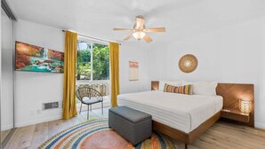 A bedroom with a bed, a ceiling fan, a window with curtains, a painting, and a rug. - Amazing Ocean Views-Walk Out Beach Access - Spacious living room area- North Coast Village G35 (Oceanside)