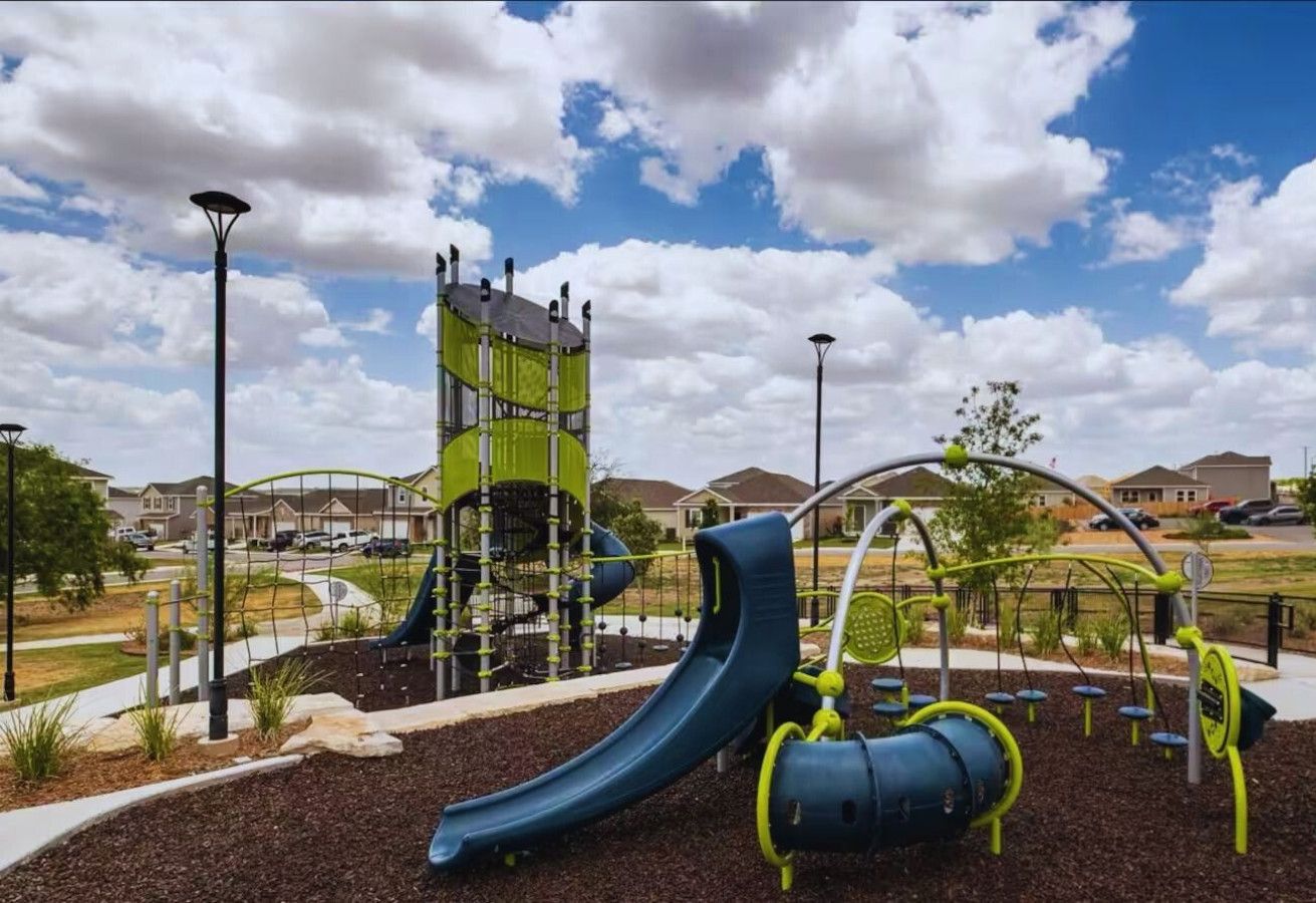 Un parque infantil con tobogán, estructuras para escalar y equipo de ejercicio.