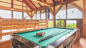 A pool table with balls and cues, wooden benches, and large windows with views of birds flying. - Vineyard House Marijan w/ Panoramic Views, Ljutomer, Slovenia (Ljutomer)