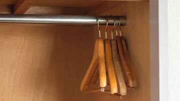 A wooden drawer with a metal rod and wooden handles.
