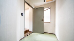 Un pasillo estrecho con una puerta que da a una habitación.