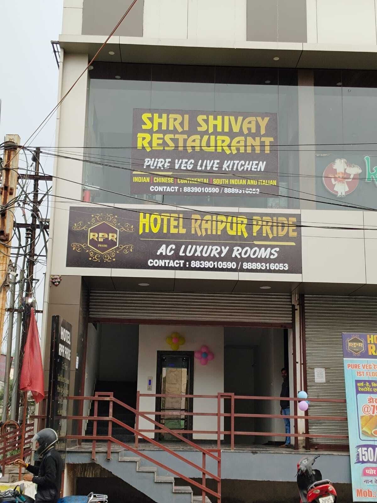 A building with signs for 'SHRI SHIVAY RESTAURANT' and 'HOTEL RAIPUR PRIDE'.
