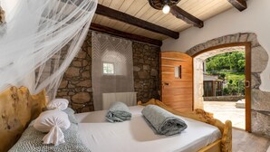 A wooden bed with a white mattress, two pillows, and a canopy. - Villa Zaria (Kvarner - Mošćenička Draga) (Mošćenička Draga)
