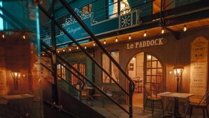 A cozy interior with a staircase leading to a bar area named "Le Paddock." - Vintage Loft Garage Proche du Parc Le Pal (Saint-Agnan)