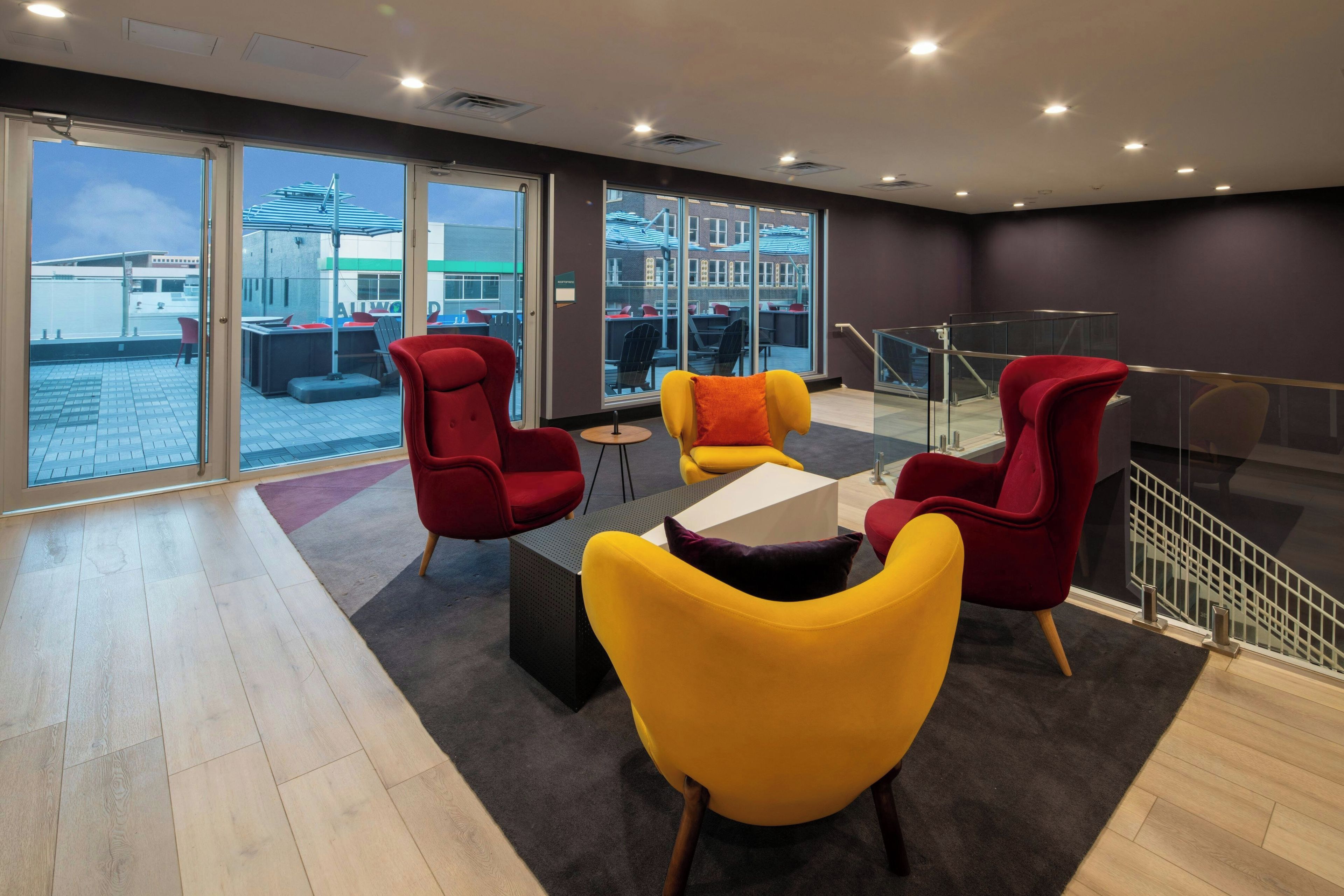 A modern lounge area with seating and a view of the cityscape.