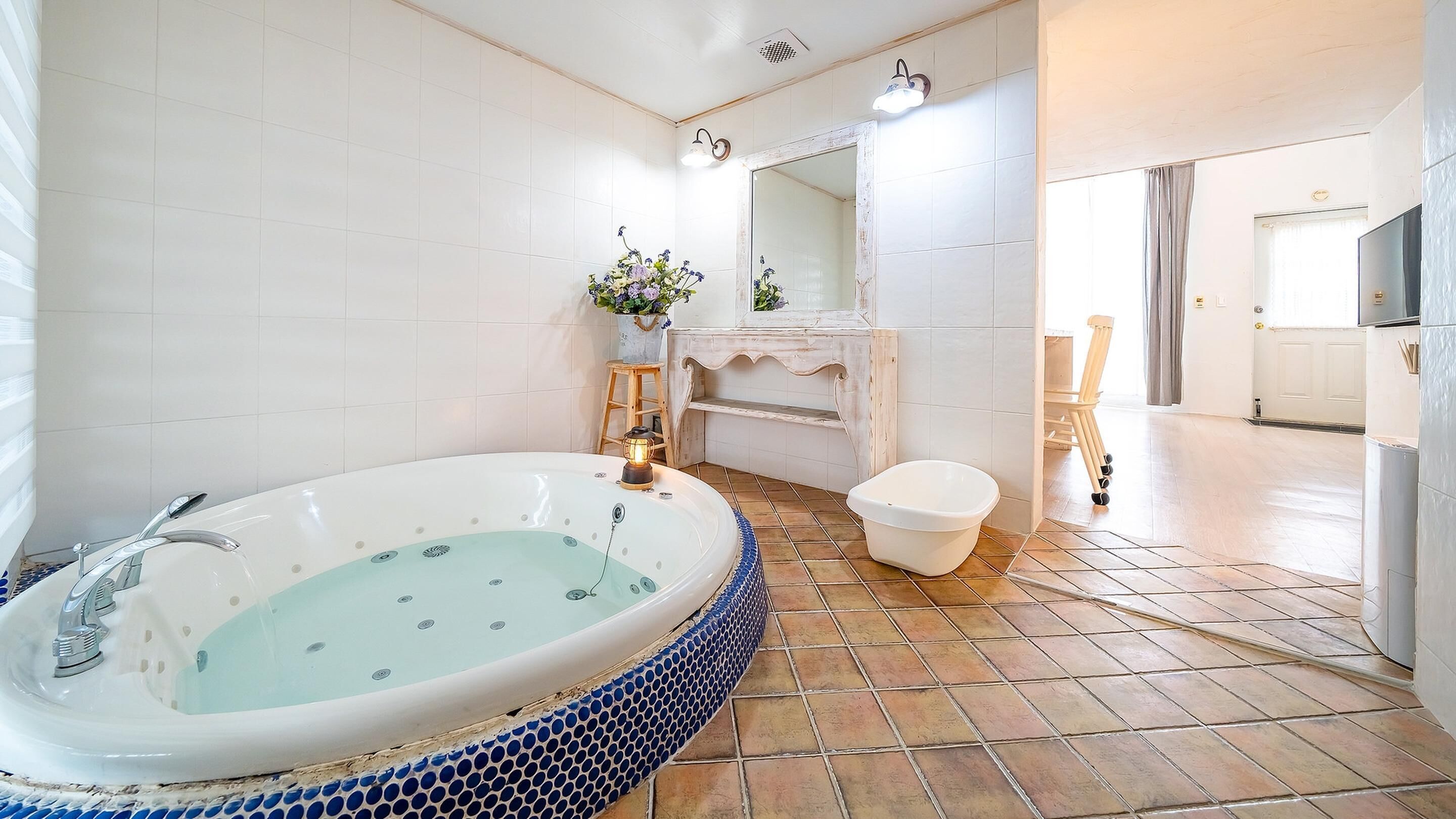 A bathroom with a large bathtub, a sink, and a toilet.