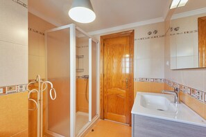 Shower, hair dryer, towels, toilet paper